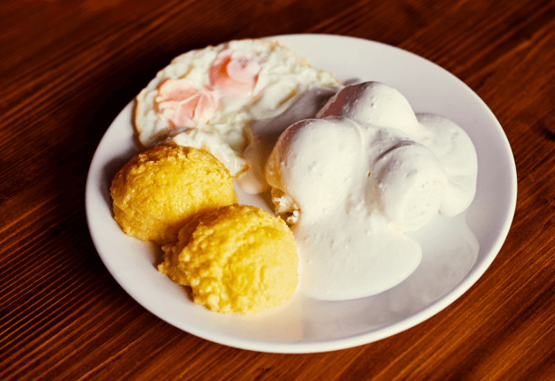 Traditional Romanian Dishes MĂMĂLIGĂ CU BRÂNZĂ ȘI CU SMÂNTÂNĂ ( Polenta With Cheese And Cream)