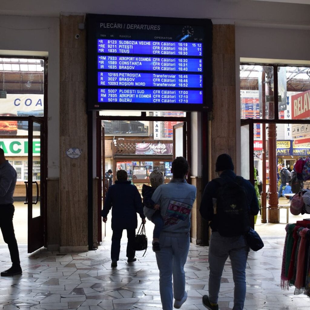 people watching timetable in Bucharest North Railway Station