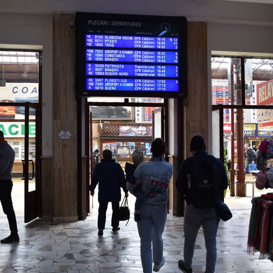 people watching timetable in Bucharest North Railway Station